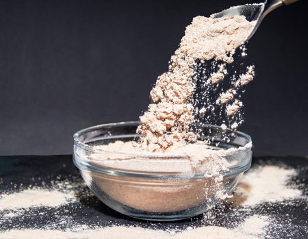 Prepared flour to cook a sponge cake served with a spoonの写真素材