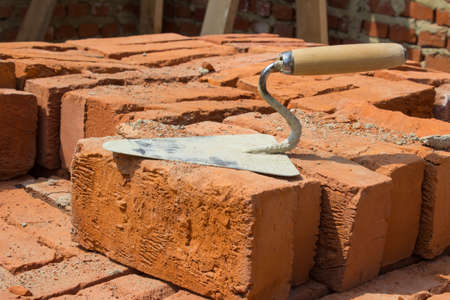 Stainless Trowel construction tool on the brick red locatedの写真素材