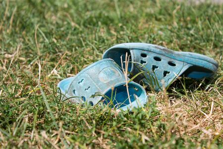 Children in the grass worn out slippers are abandoned child