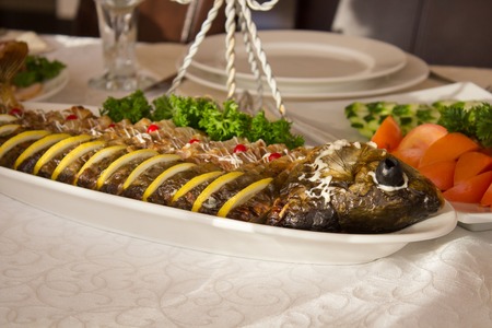 Stuffed fish with salad on the table  a restaurant