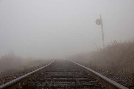 fog weather on railway track in autumn