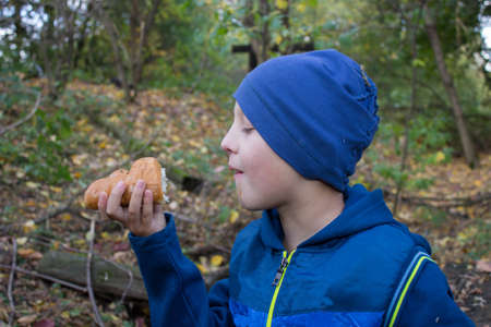 holds a bun in his hands and watch the boyの写真素材