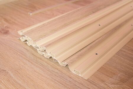 Baseboard PVC on the floor,floor repair, lie new plastic baseboardの写真素材