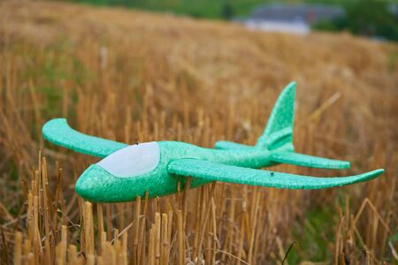 toy airplane,toy airplane with foam on the field after wheat harvest