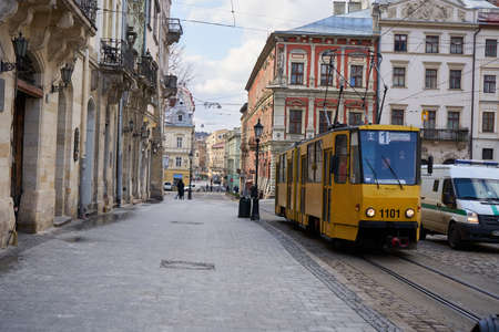 23 March 2020 Ukraine Lviv,an old tram runs on an empty street in the cityのeditorial素材