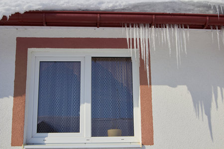 icicles melt over the window in winterの写真素材