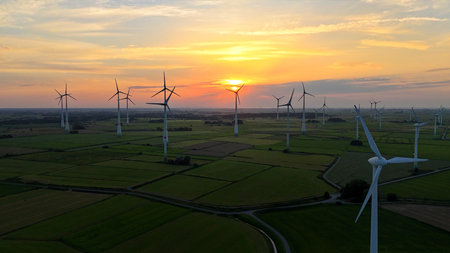 Aerial view of windmills for electric power production at sunset