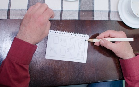 Man is making a mockup in the cafe