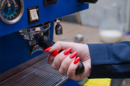 Woman making coffee with coffee machineの写真素材