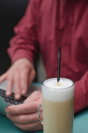 Aged man using his laptop on the tableの写真素材