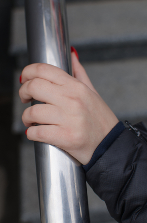 Woman's hand holding the steel hand railの写真素材