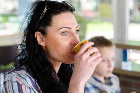 Young girl drinking cofee in the cityの写真素材