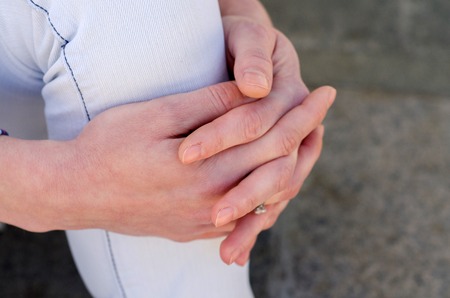 young girl sitting on the steps and resting in the shadowの写真素材