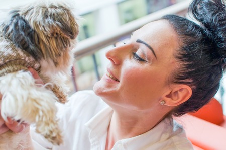 Woman with a small dog and paper bagsの写真素材