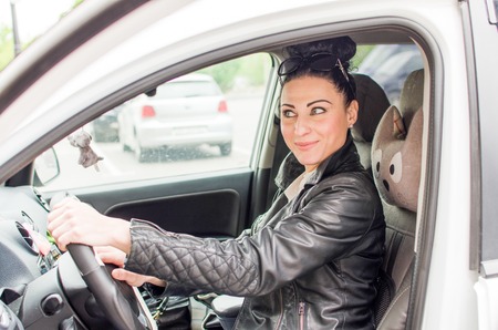 Young woman sitting in the silver car