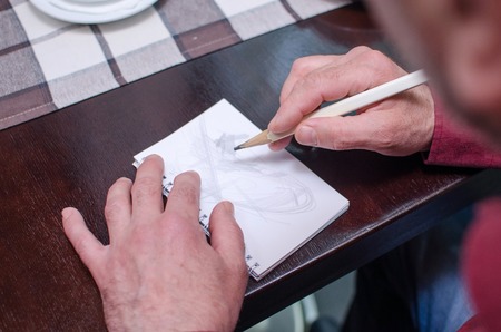 Man is making a mockup in the cafeの写真素材