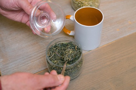 Aged man making tea on the kitchenの写真素材