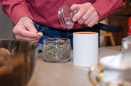 Aged man making tea on the kitchen