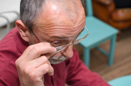 Closeup of man in glasses in the cafeの写真素材