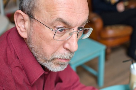 Closeup of man in glasses in the cafeの写真素材