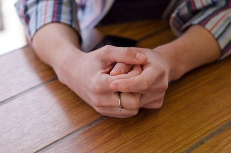 young girl sitting in empty restaurantの写真素材