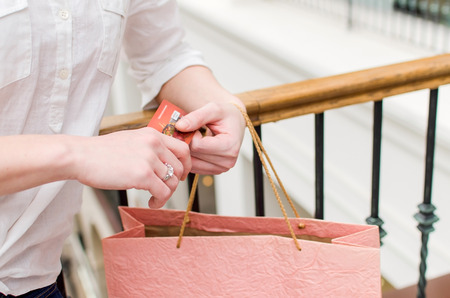 Young woman in the shopping mall with a credit cardの写真素材