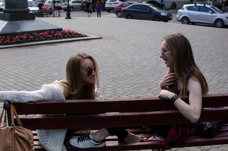 Two girlfriends are resting in the parkの写真素材