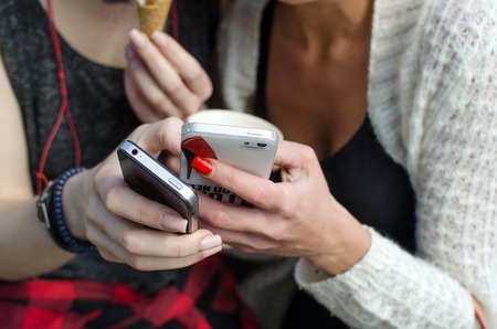 Two girlfriends are making selfie on the streetの写真素材