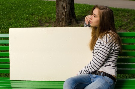 Young girl with the white banner in the cityの写真素材