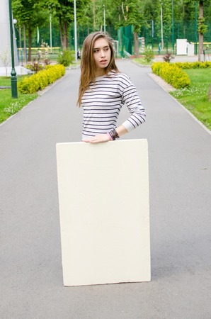 Young girl with the white banner in the cityの写真素材