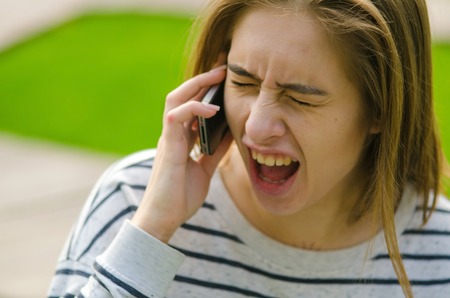 Young woman using her phone on the streetの写真素材