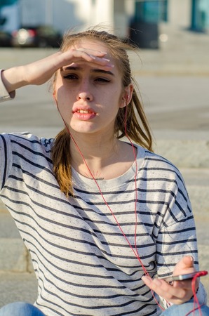 Young woman listening to music in headphones