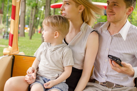 Young family is having fun in the park during the summerの写真素材