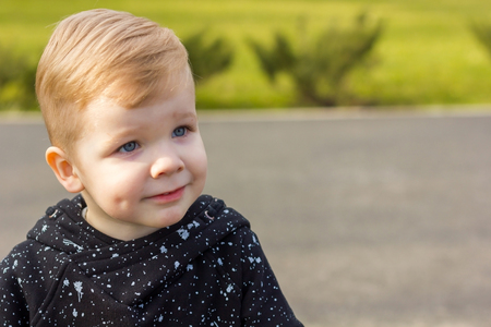 Close-up photo of little boy looking aside