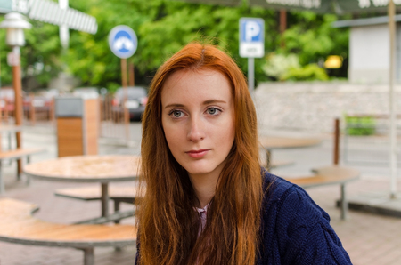 Young red woman walking and resting in the city
