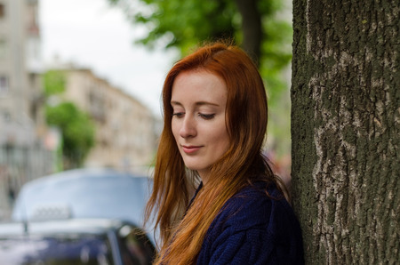 Young red woman walking and resting in the city