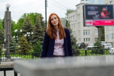 Young red woman walking and resting in the cityの写真素材