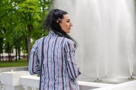 Young girl resting at fountainの写真素材