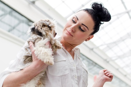 Woman with a small dog and paper bagsの写真素材