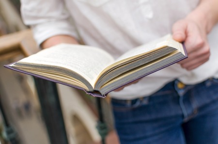 Young woman in the shopping mall with a bookの写真素材