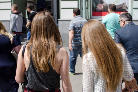 Two girlfriends are walking on the city streetsの写真素材