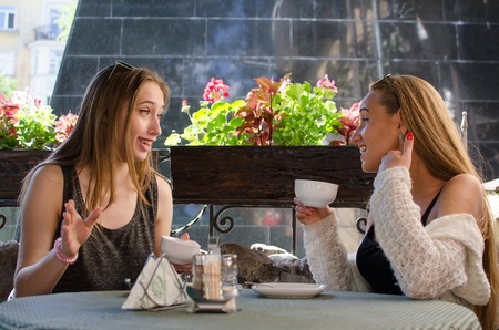 Two girlfriends are sitting in the cafeの写真素材