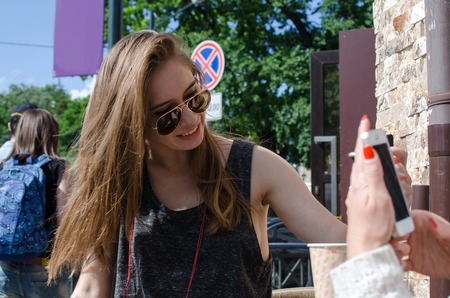 Two girlfriends are using cellphones in the cafeの写真素材