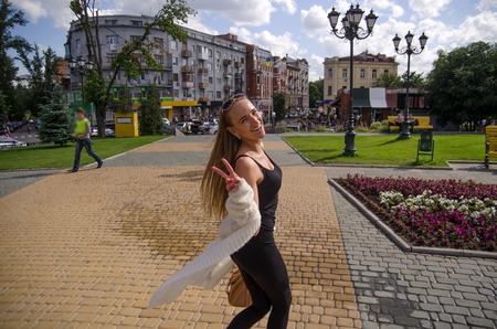 Young woman is walking in the city during the summerの写真素材