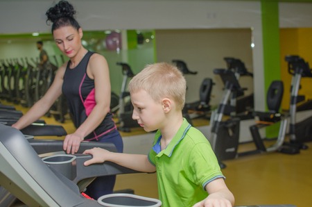 Mother and son are training in the race trackの写真素材