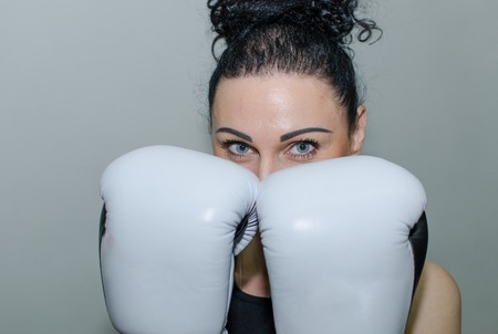 Young woman is training in the boxing glovesの写真素材