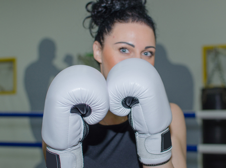 Young woman is training in the boxing glovesの写真素材