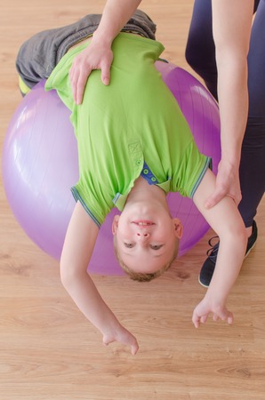 Woman is making exercises with her sonの写真素材