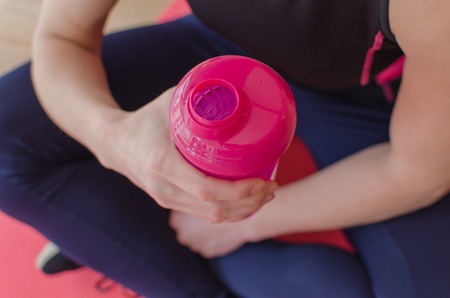 Young woman is drinking water after the trainingの写真素材