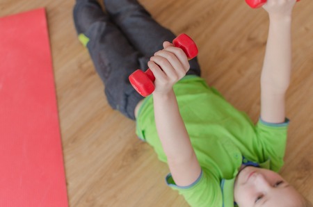 Young boy is making sports exercisesの写真素材